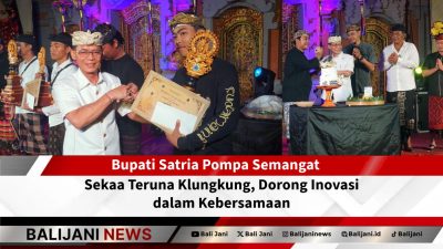 Bupati Klungkung I Made Satria menyerahkan piala kepada pemenang lomba dalam HUT Sekaa Teruna Kertha Mandala ke-61 di Desa Adat Kemoning