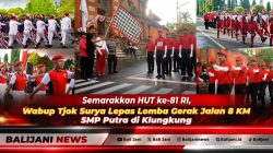 Wakil Bupati Klungkung Tjokorda Gde Surya Putra mengibarkan bendera start melepas Lomba Gerak Jalan 8 KM SMP Putra di depan Puri Agung Klungkung